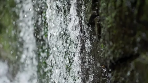 Close Up of Waterfall Streaming Down Rocky Cliff Face Stock Footage 335462467