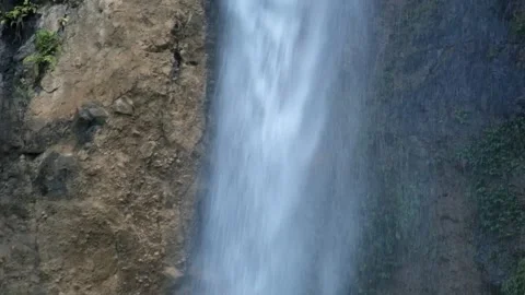 Close up of a waterfall in a tropical rainforest mountain flowing rapidly Stock Footage 319879072