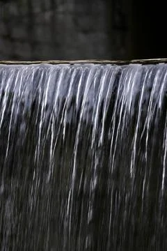 A close-up of a waterfall, which is an artificial element of landscape design Stock Photos