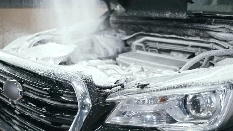 Close up of watering car engine compartment with foam from high pressure hose Stock Footage 168486688