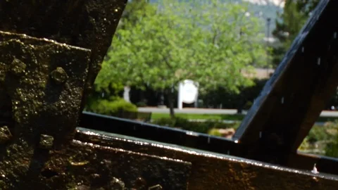 Close Up Of A Watermill Spinning With A Small Pond In The Background Stock Footage 90239351