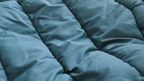 Close-up waterproof fabric texture of green winter emerald, down jacket. Textile Видео 227351624