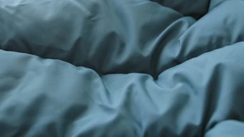 Close-up waterproof fabric texture of green winter emerald, down jacket. Textile Stock Footage 227351686