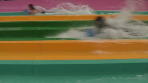 Close-up Waterslide People Splashing By Fast Thrill Stock Footage 25970982