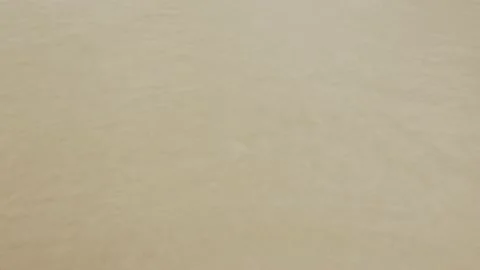 Close up to the wave with foam while hits white sand smooth beach with turquo Stock Footage 218364350