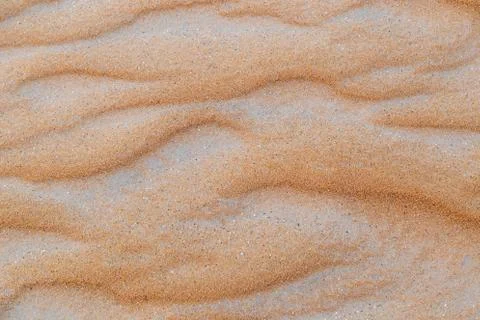 Close up of wave sand dunes pattern. Desert sand background or texture. Stock Photos