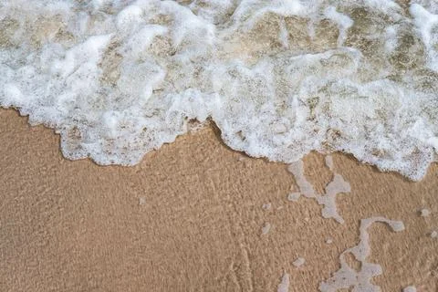 Close-up of wave on sandy beach with copy space for your text, top view backg 写真素材