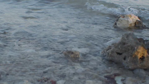 Close up of waves and stones at beach in Muharraq Видео 309202888