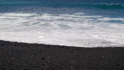 Close up of waves on a black sand beach in Lanzarote, Canary islands, Spain Video stock 74659786