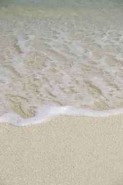 Close-up of waves breaking on the beach Stock Photos