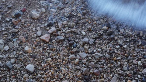 Close up of waves breaking on the pebbles beach. Stock Footage 94320119