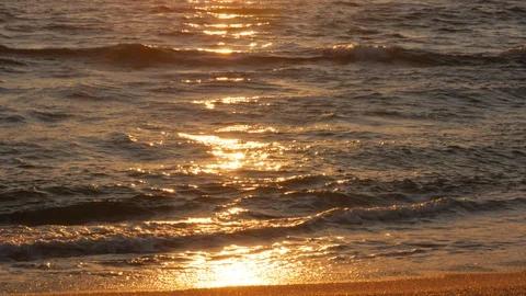 Close up of waves breaking on shore at sunset Stock Footage 110619335