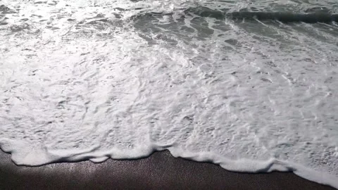 Close-up waves crash on sandy beach Stock Footage 307911165