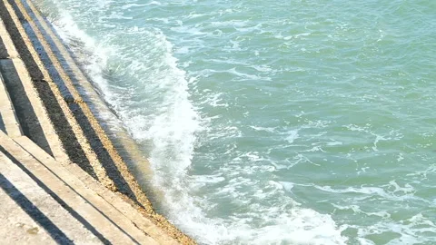 Close up of waves crashing against steps Stock Footage 244864602