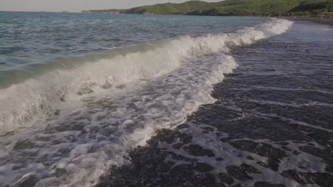 Close up of waves crashing on an empty beach Stock Footage 131393686