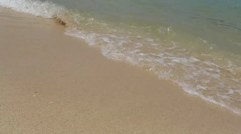 Close Waves crashing gently on sandy beach Stock Footage 48786744