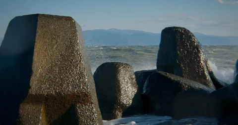 Close Up of Waves Crashing Off Rocks on the Coast of Japan Stock Footage 125716341