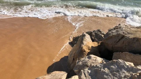 Close up of waves crashing on sandy beach Vilamoura Portugal Stock Footage 98413579