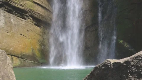 Close up of the waves in the deep pool at the lower part of the waterfall. 4K Stock Footage 260238561