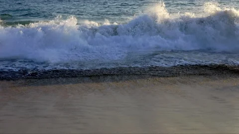 Close up of waves hitting a beach Видео 266440354
