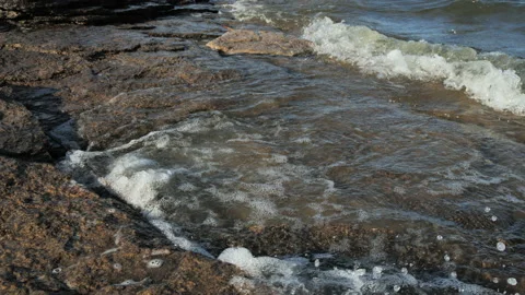 Close-up of waves hitting the rocky shore Stock Footage 146892257