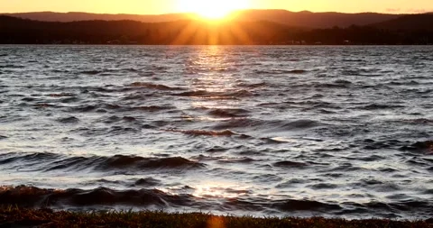 Close up of waves on lake at sunset Stock Footage 211066332