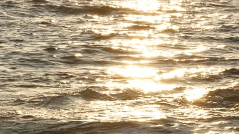 Close up waves on ocean at sunset with sun reflections Stock Footage 111402617