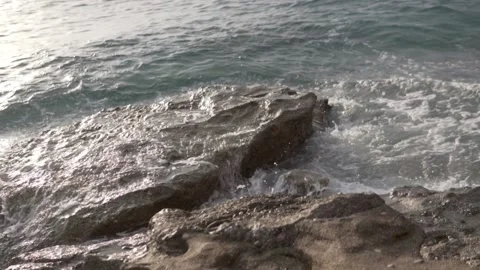 Close-up, waves on a rock by the sea, a cloudy day. Stock Footage 219545865