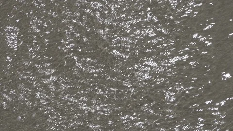Close up of waves rolling in and out across the hard wet sand￼. Stock Footage 121320672