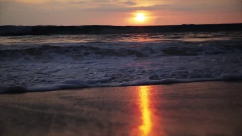 Close Up Of Waves Rolling Up The Sandy Beach at sunset Stock Footage 75465133