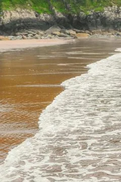 Close up of waves on the shore of a beach Stock Photos
