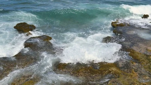CLOSE UP-Waves splash onto rocky shore line on the Puerto Rico north shore Stock Footage 73753172