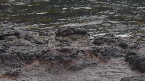 Close up of waves splashing over rocks Видео 295079974
