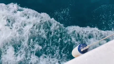 Close-up of waves splashing from a sailing motor yacht with wing boating Stock Footage 246992725