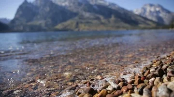 Close Up Waves Splashing on Stones of Mountain Lake Shore Stock Footage 85528051