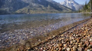 Close Up Waves Splashing on Stones of Mountain Lake Shore Stock Footage 85528225