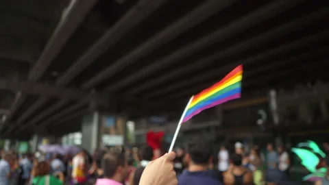 Close-up Waving rainbow flag on hand for celebration moment in Pride month. Stock Footage 276688329