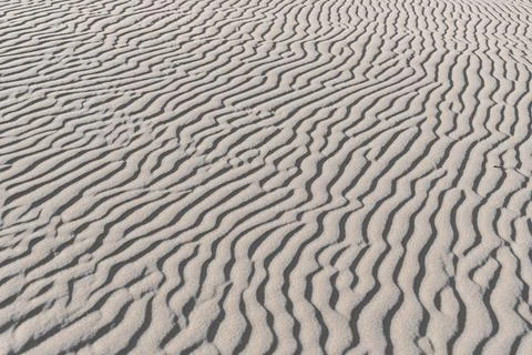 Close-up of wavy sand patterns created by the wind in a desert Stock Photos