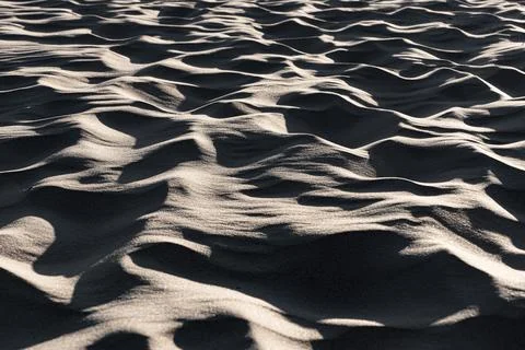 Close-up of wavy sand patterns created by the wind in a desert Stock Photos