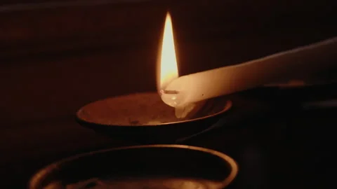 Close up of wax drops melting from burning church candle with bright flame 動画素材 342113056