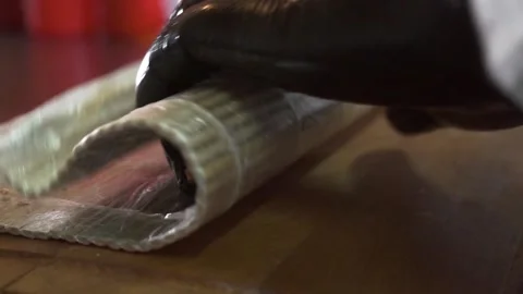 Close up. We prepare sushi, prepare rolls in the kitchen. Twists rice and salmon 库存影片 132037721