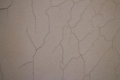 Close up of weathered beige wall with complex dry paint crack patterns 写真素材