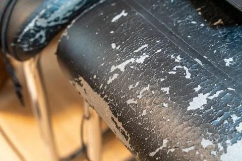Close-up of weathered black leather surface showing cracks and peeling, ideal Stock Photos