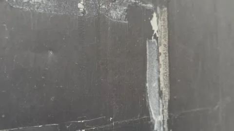 Close-up of weathered black wall texture with rough surfaces Stock Footage 312096873