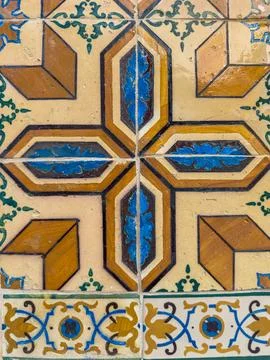 Close-up of weathered ceramic tiles featuring a bold geometric cross design.. Stock Photos