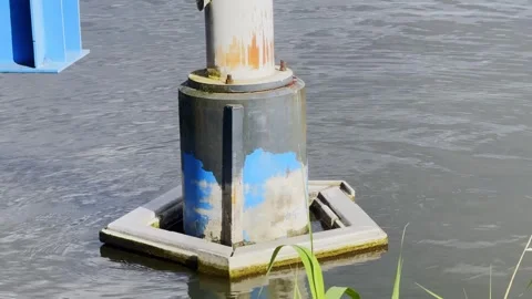 Close-up of a weathered cylindrical support column surrounded by a square Stock Footage 344009876