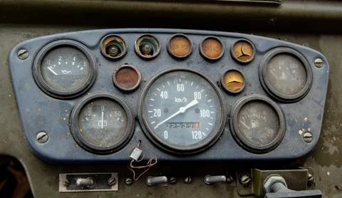 Close-up of a weathered dashboard with multiple analog gauges, including a .. Stock Photos