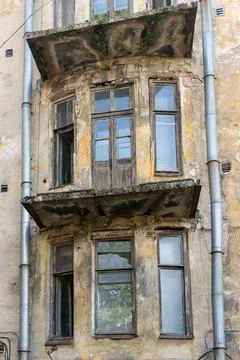 Close-up of a weathered facade of an old building with a crumbling bay Stock Photos