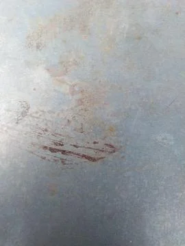 Close-up of a weathered metal surface with rust and scratches. Stock Photos