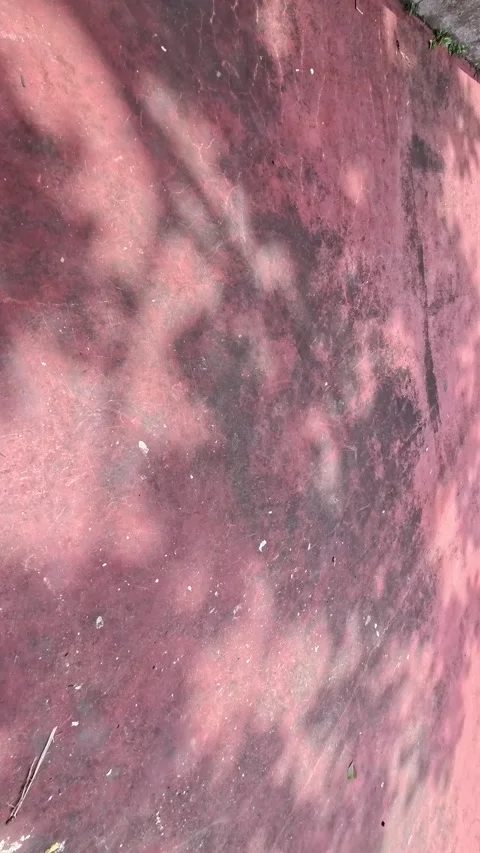 A close-up of a weathered, pink surface with dark, indistinct shadows. Abst.. Stock Footage 305880957